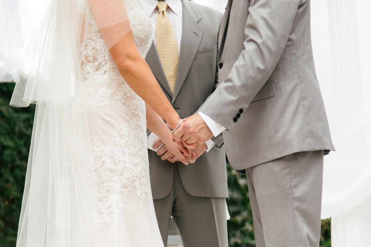 Bride and groom hold hands at 1880 Union Hotel Wedding