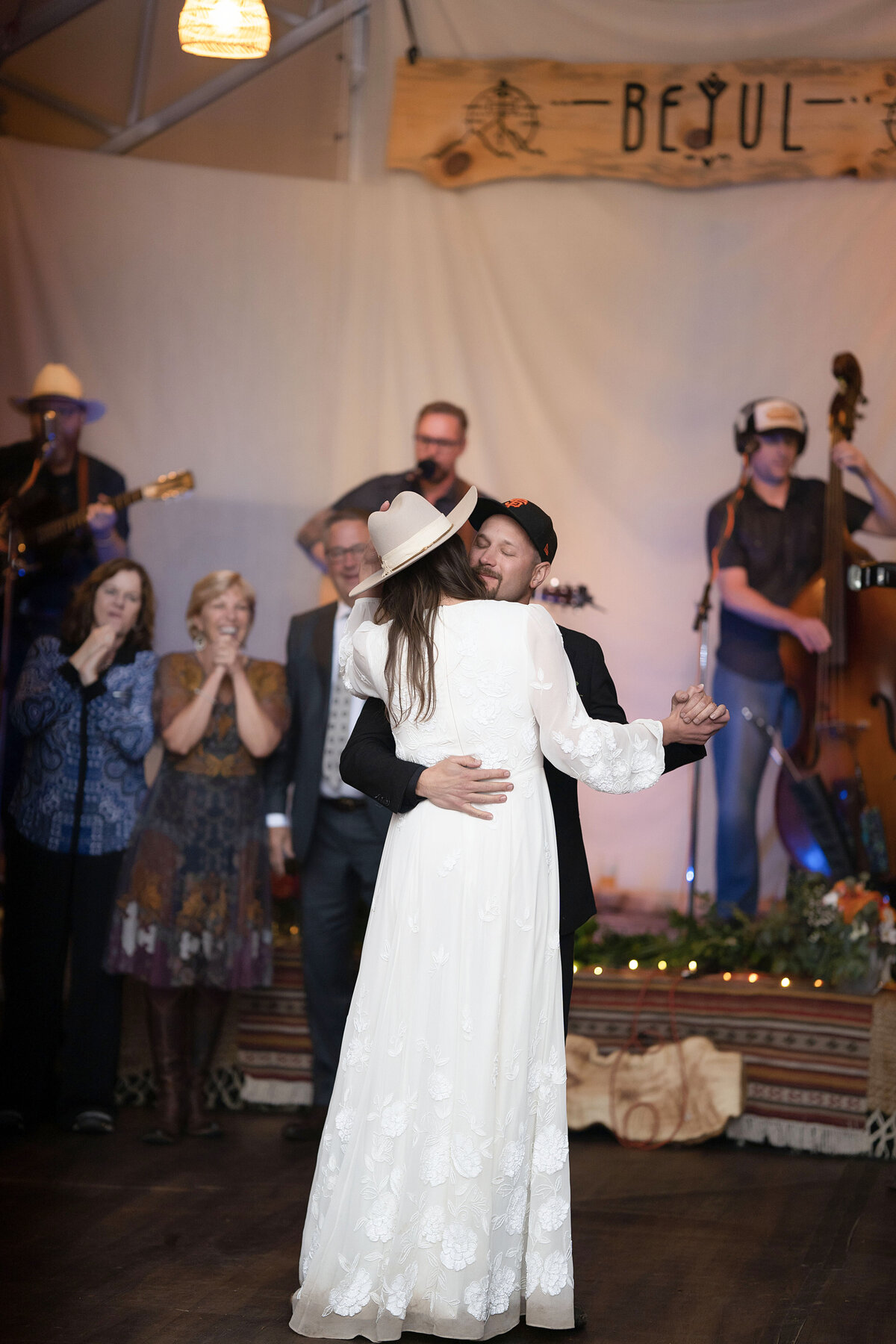 Bride and groom embrace for a slow dance on their wedding night in Aspen, Colorado,
