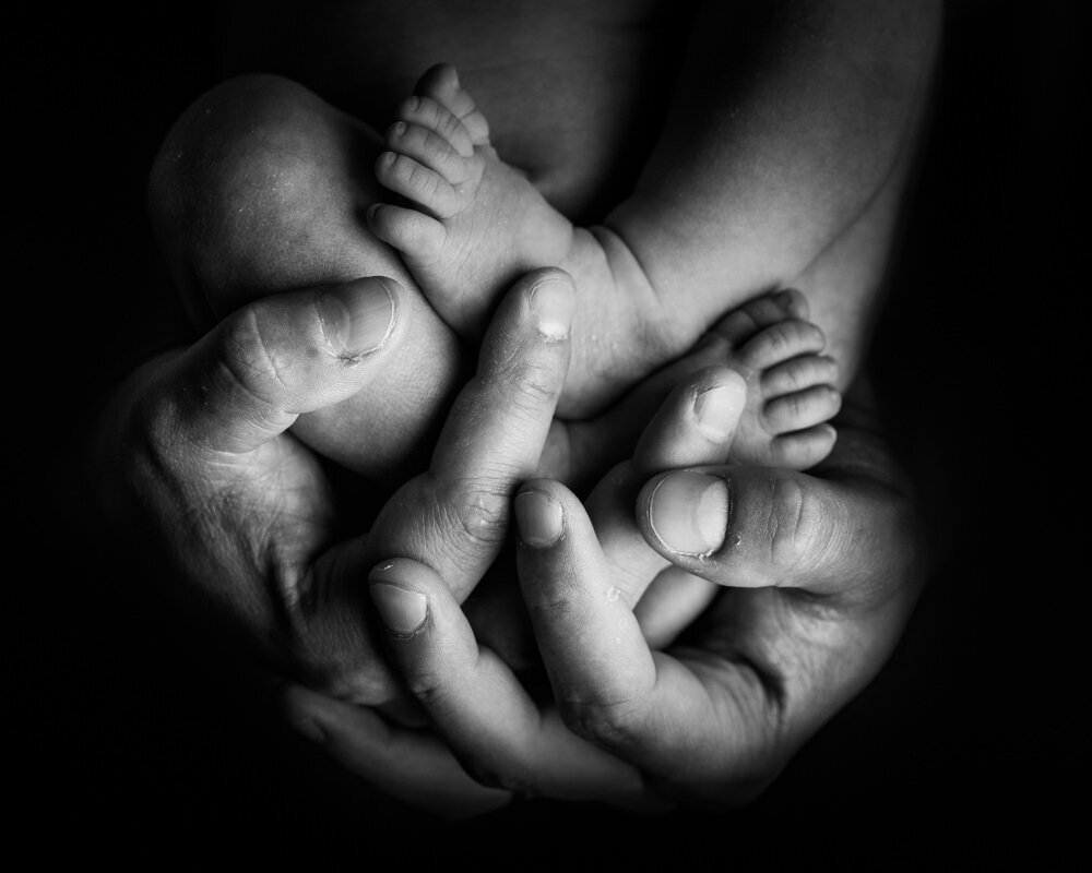 Un instant d'amour éternel capturé en noir et blanc par un photographe artistique de nouveau-nés à Bordeaux. Découvrez une photographie qui célèbre la délicatesse et la force du lien parental dès les premiers jours de vie.
