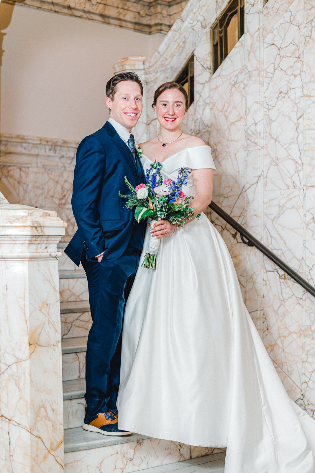 bride and groom on marble staircase omaha