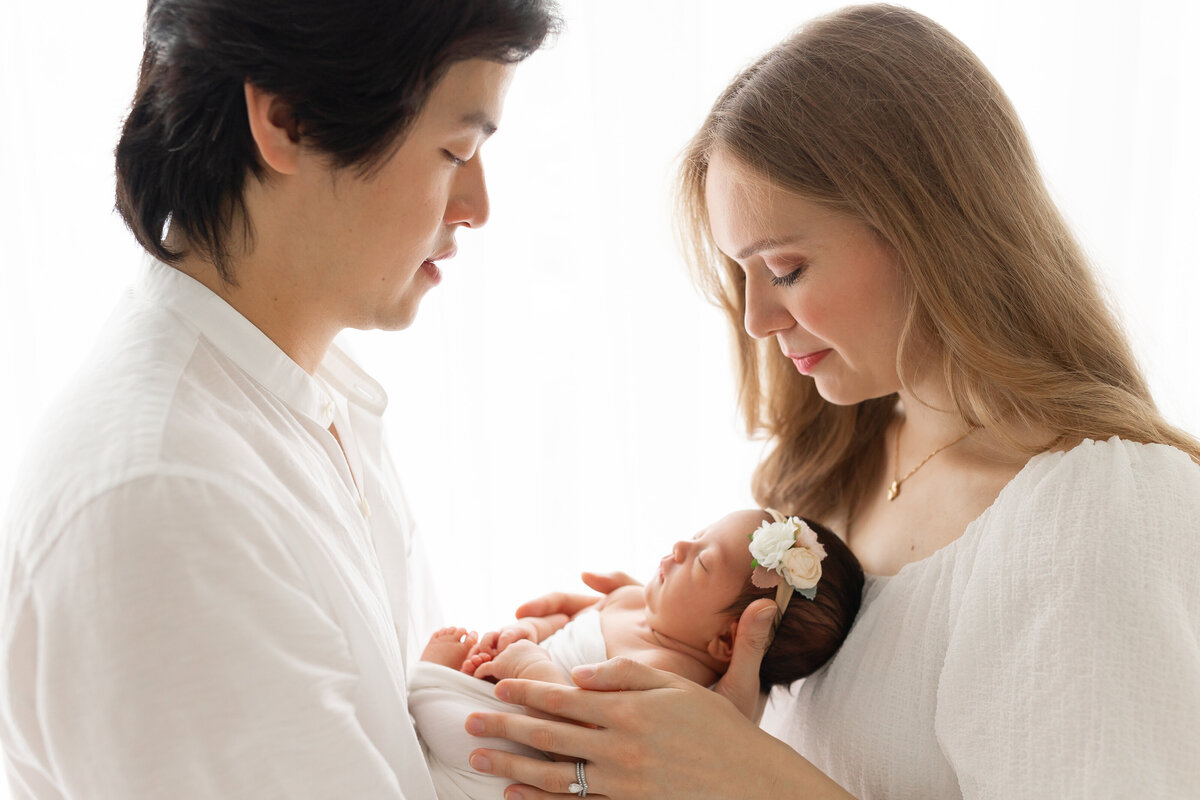 new parents looking at new baby