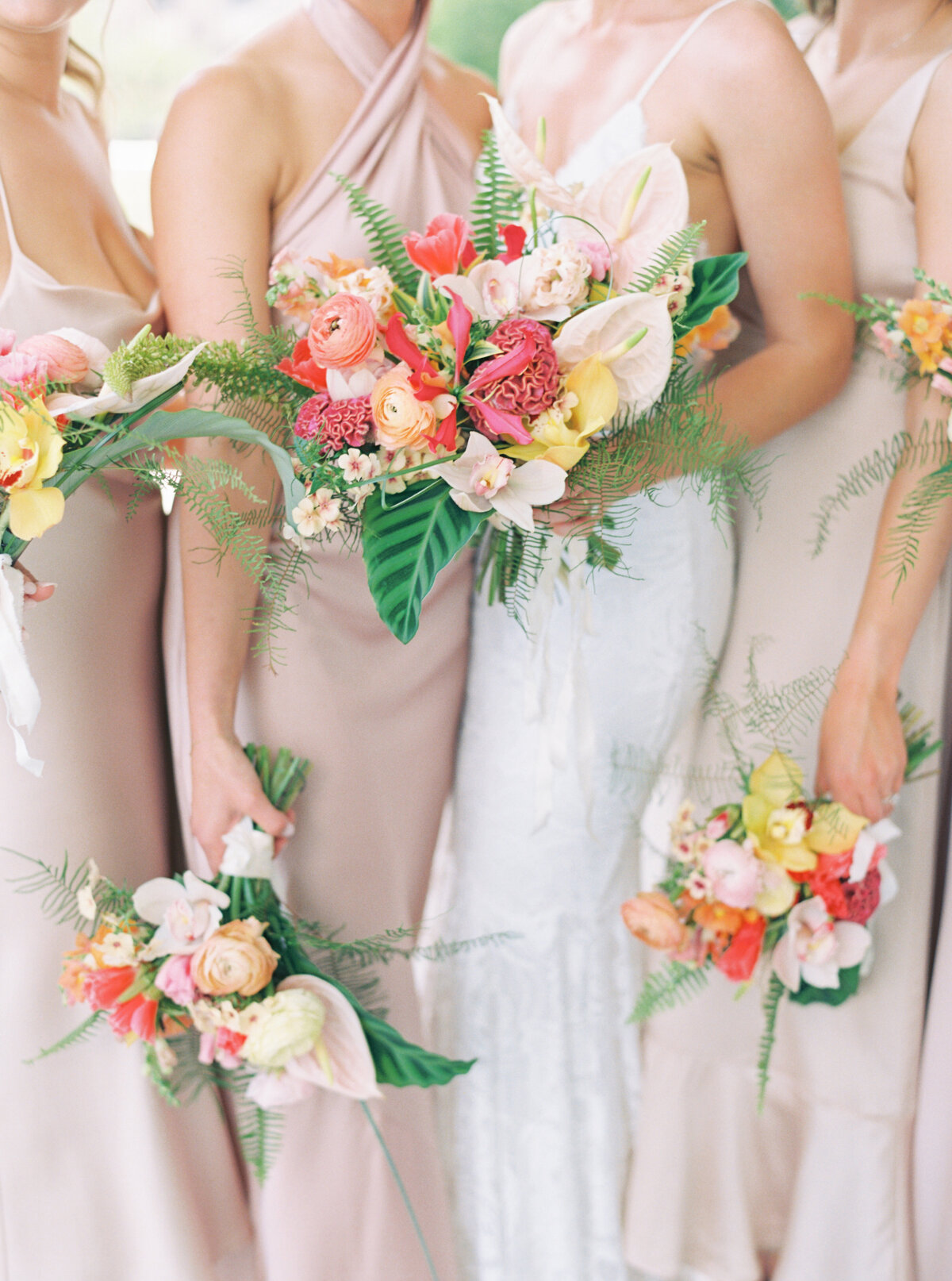 Tropical bride and bridesmaids flowers. Colorful spring Gadsden House wedding. Bridesmaids in muted dresses with pop of color tropical flowers.