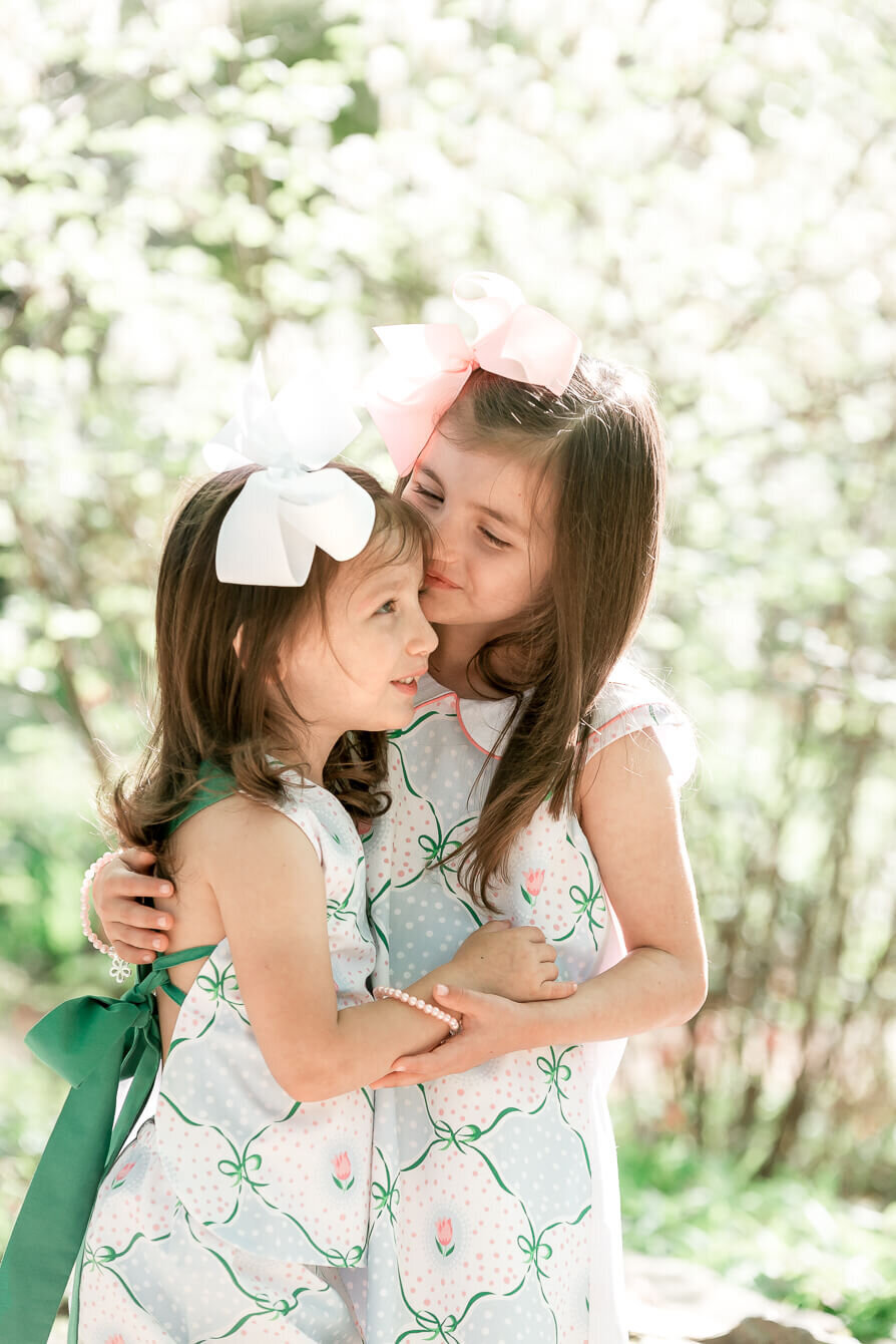 big sister kissing young sister