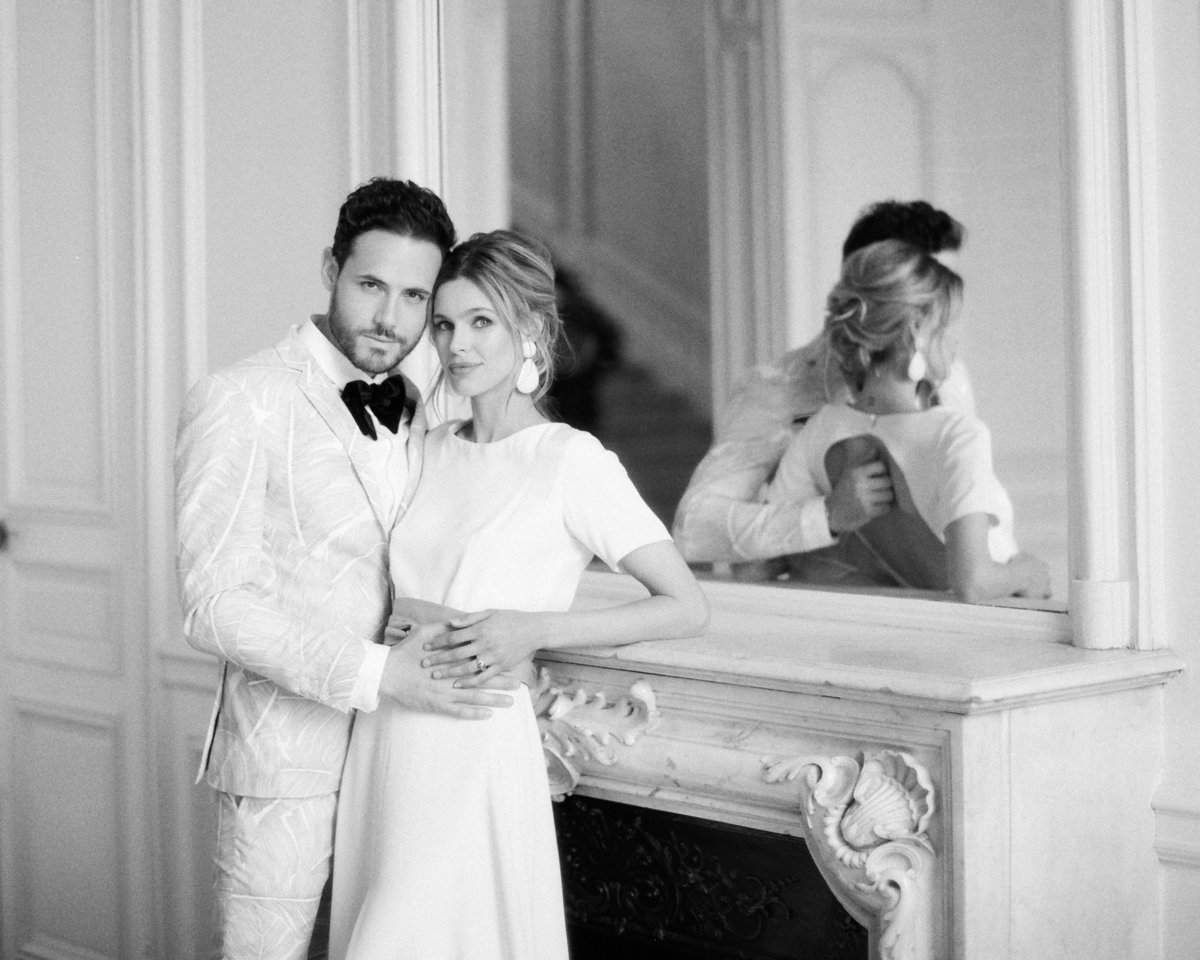 Young couple embrace in French chateau during elopement
