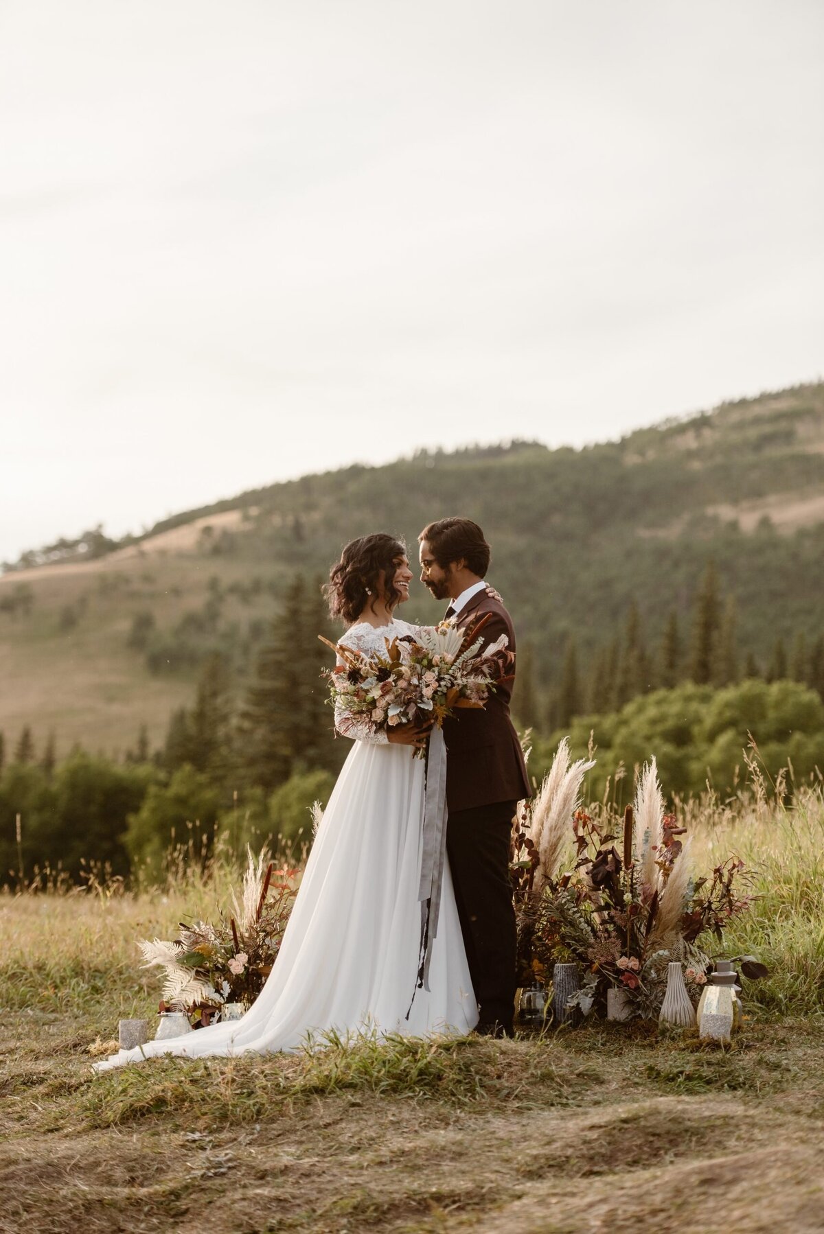 Bride wearing stunning two piece lace bridal gown from Cameo & Cufflinks, a contemporary bridal boutique based in Calgary, Alberta. Featured on the Brontë Bride Vendor Guide.