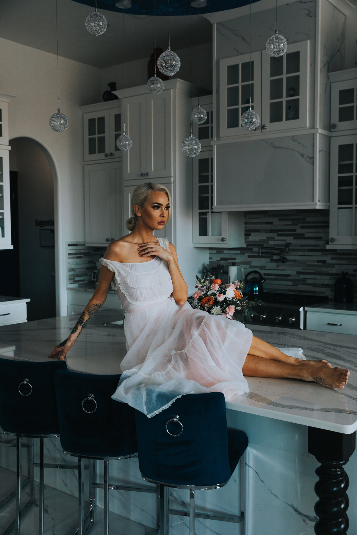 woman sitting on kitchen counter in a beautiful sheer gown