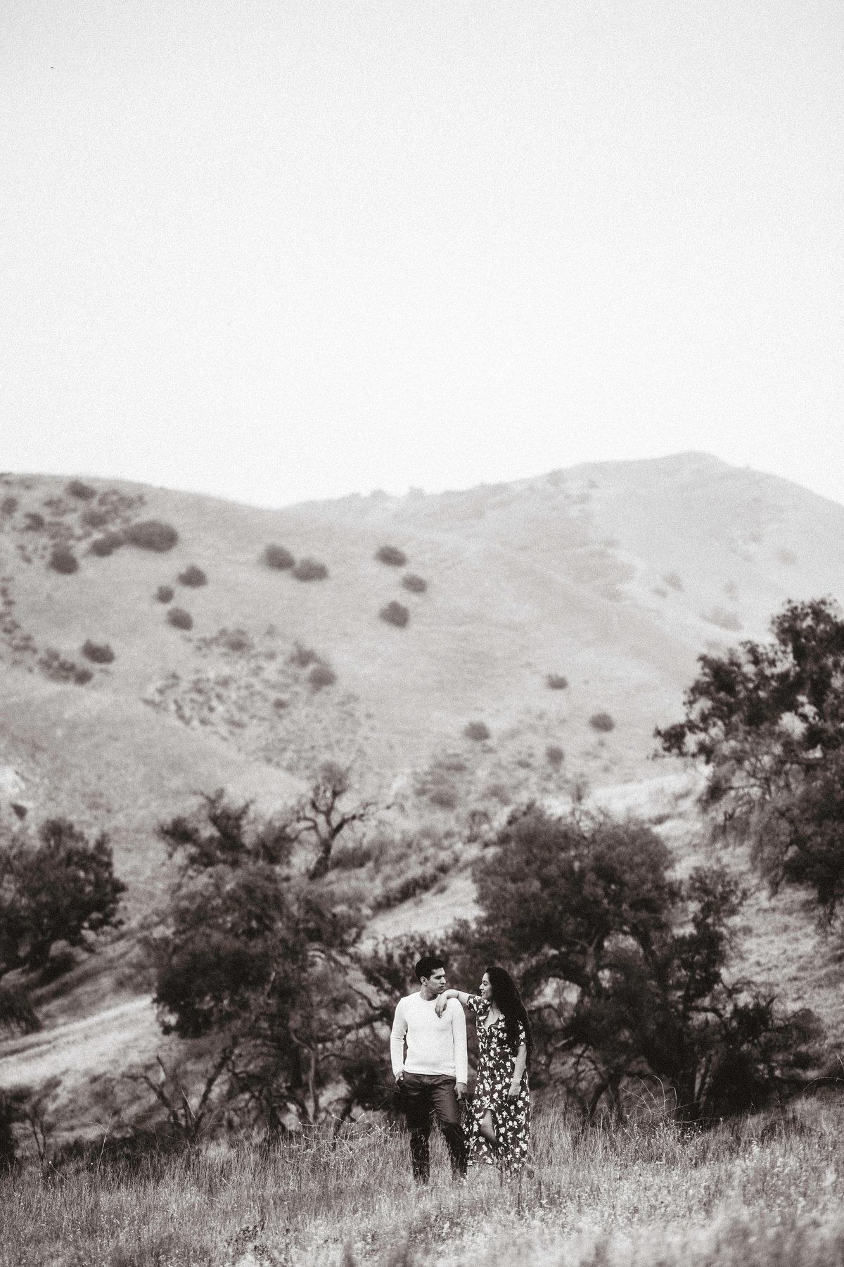Engagement Photograph Of  Man And Woman Staring At Each Other In  The Middle Of a Meadow Los Angeles