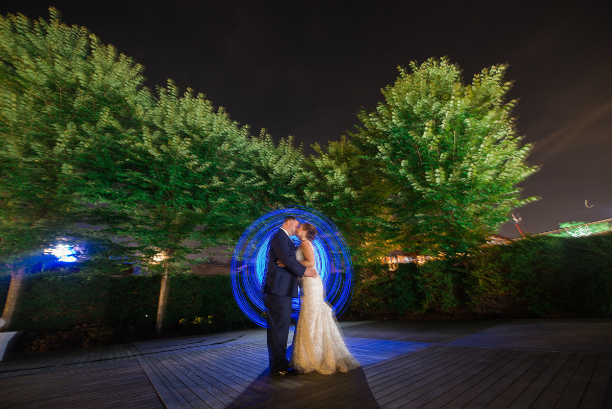 Night photo with bride and groom at Harbor club at prime with blue lights