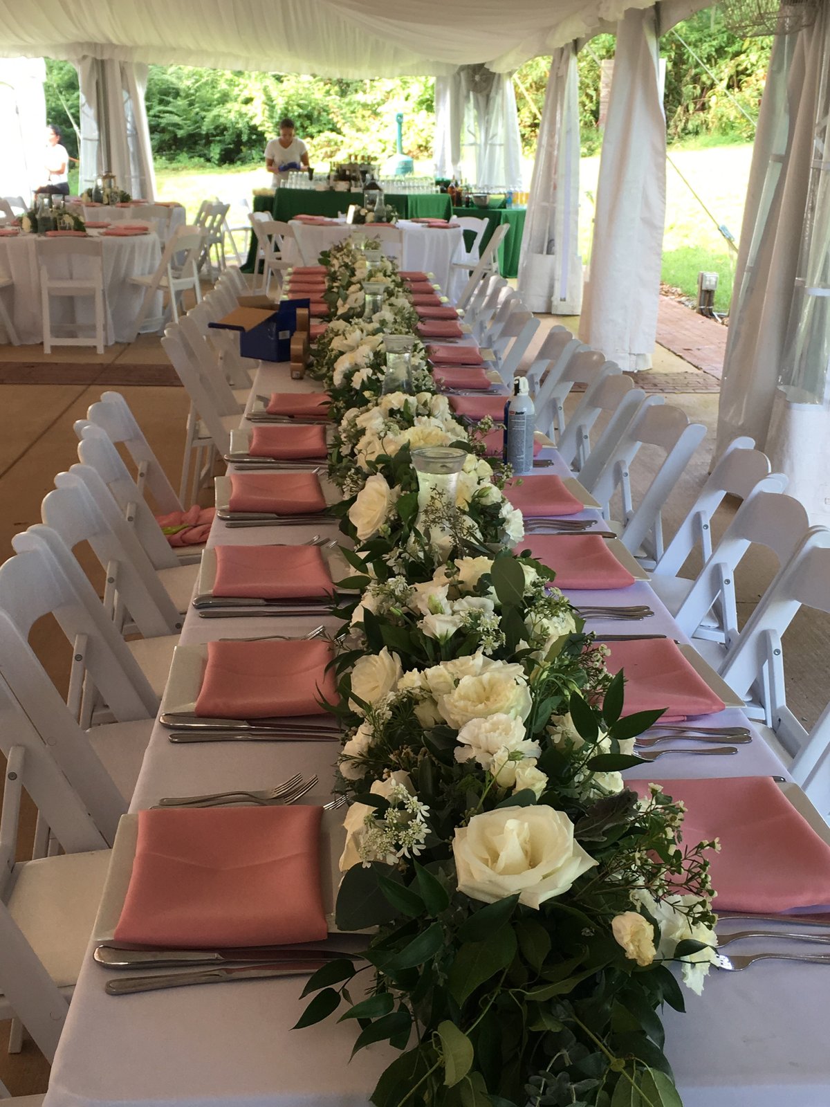 White floral garland on a head table under the tent at Oatlands Plantation