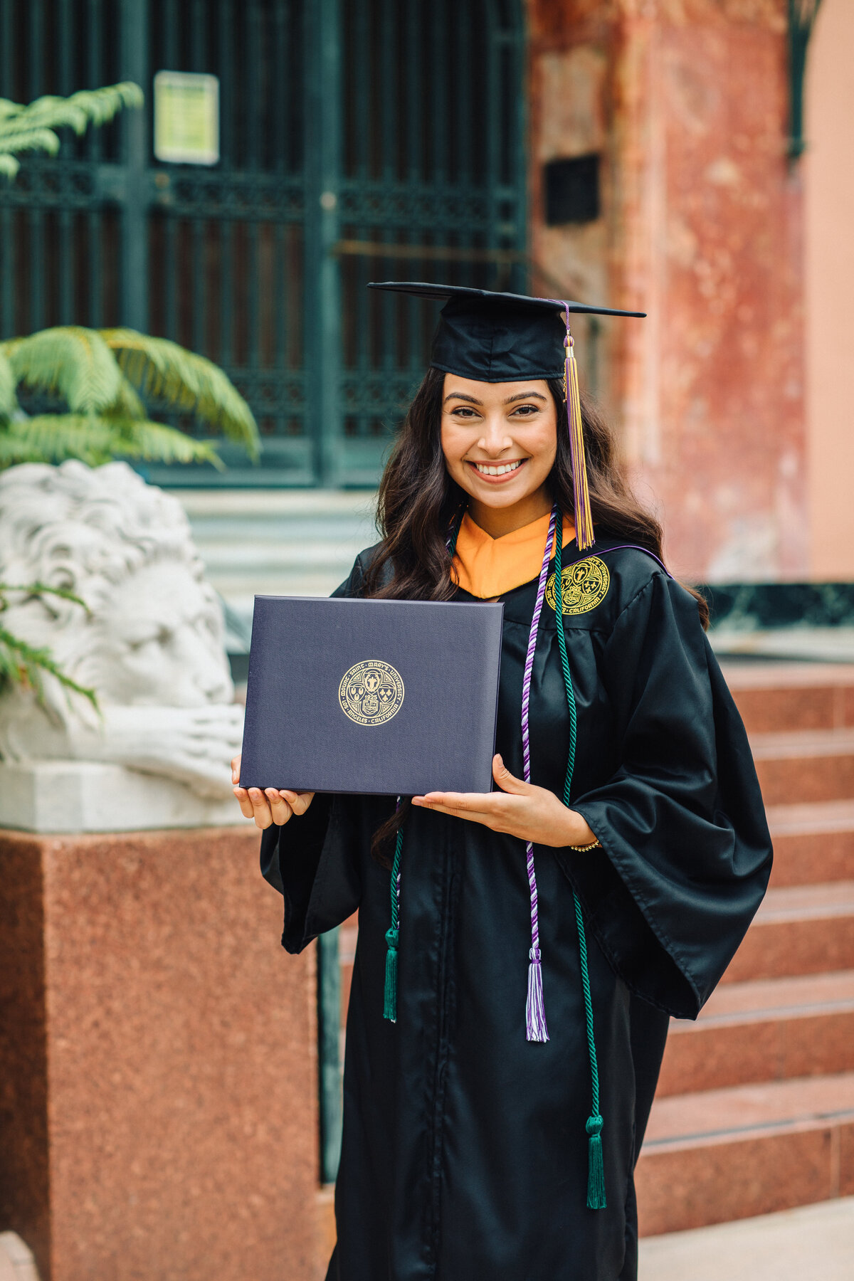 Graduation Portrait Of Young Woman Showing Her Diploma Los Angeles