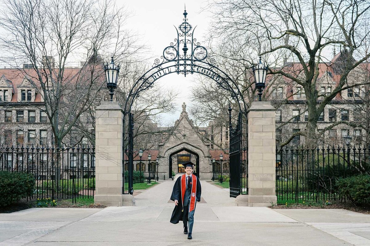 University of Chicago graduate walking across campus for his senior guy pictures
