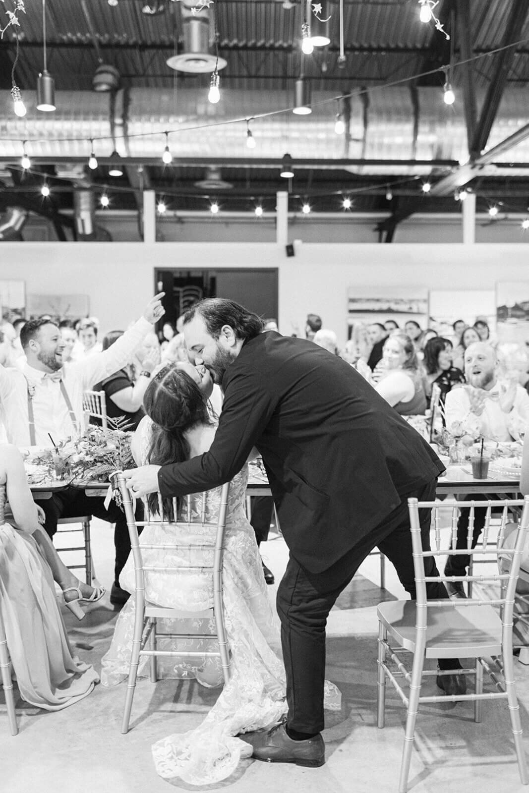 groom-kisses-bride-at-wedding-reception