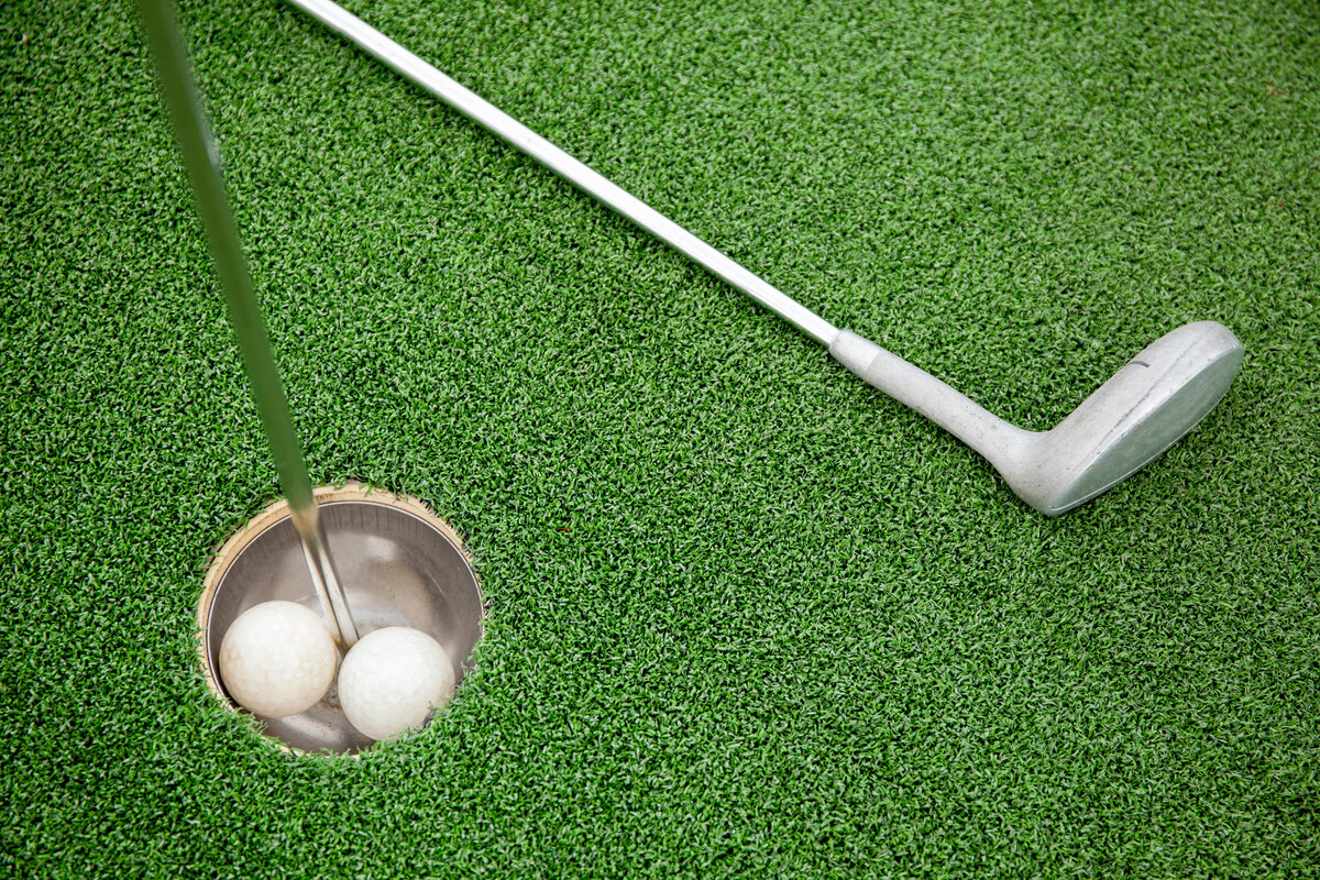 putting-golf-club-on-green-grass-with-golf-ball-in-2022-12-16-09-55-27-utc