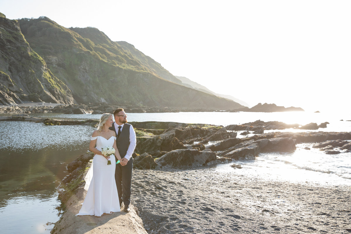 Beautiful evening light portrait of couple at Tunnels Beaches in Devon