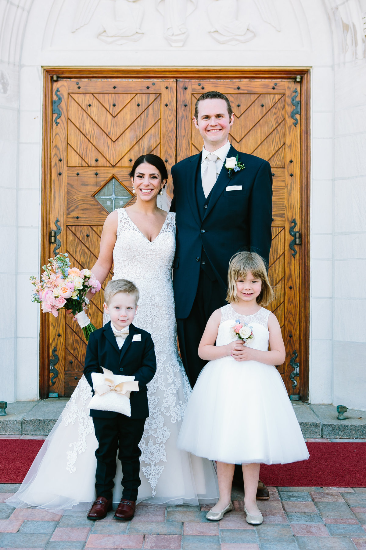 bride and groom with ring bearer and flower girl