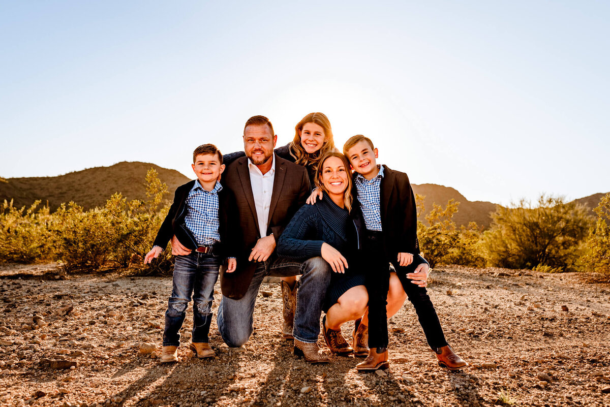 family playing in the desert for their portrait session with phoenix photographer
