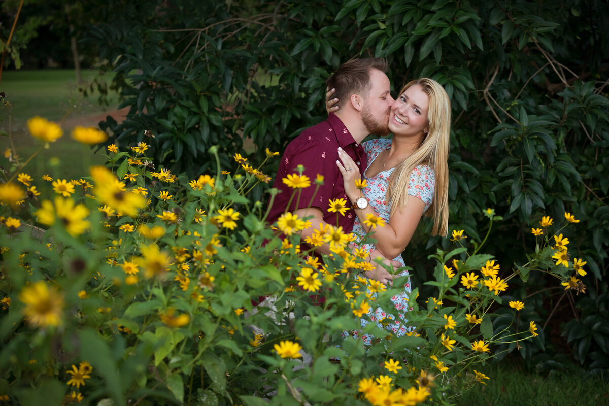engaged-couple-behind-sunflowers-colonial-park-nj