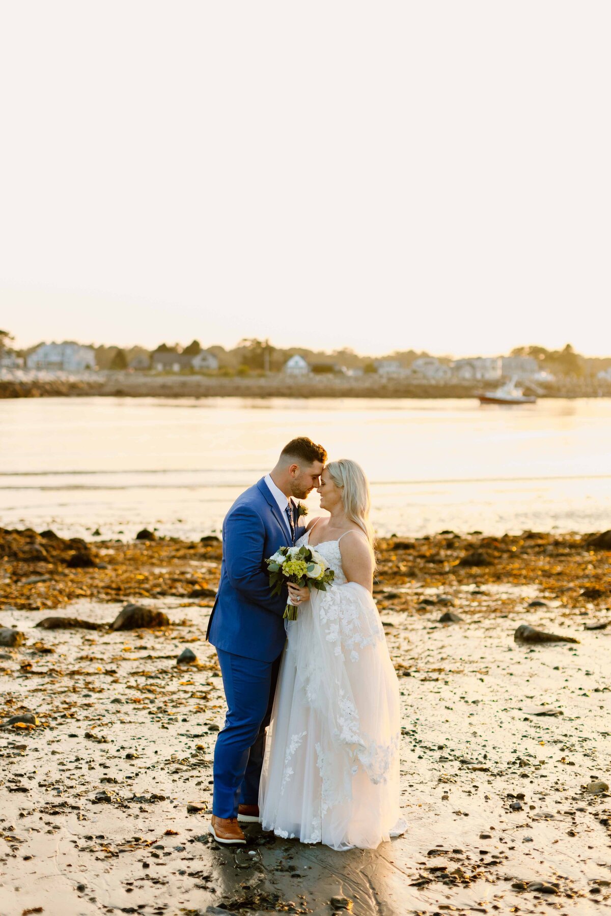 portraits of a bride and groom on the beach in new england