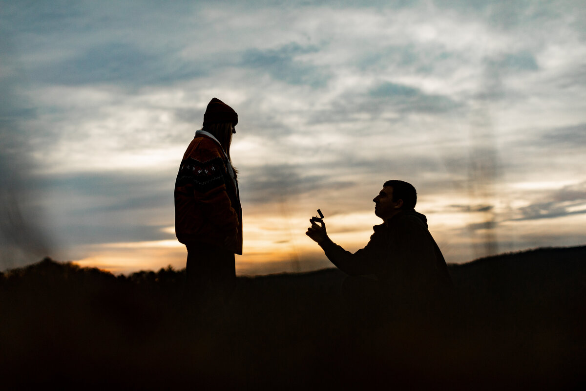 man proposing to a woman with a ring in the smoky mountains