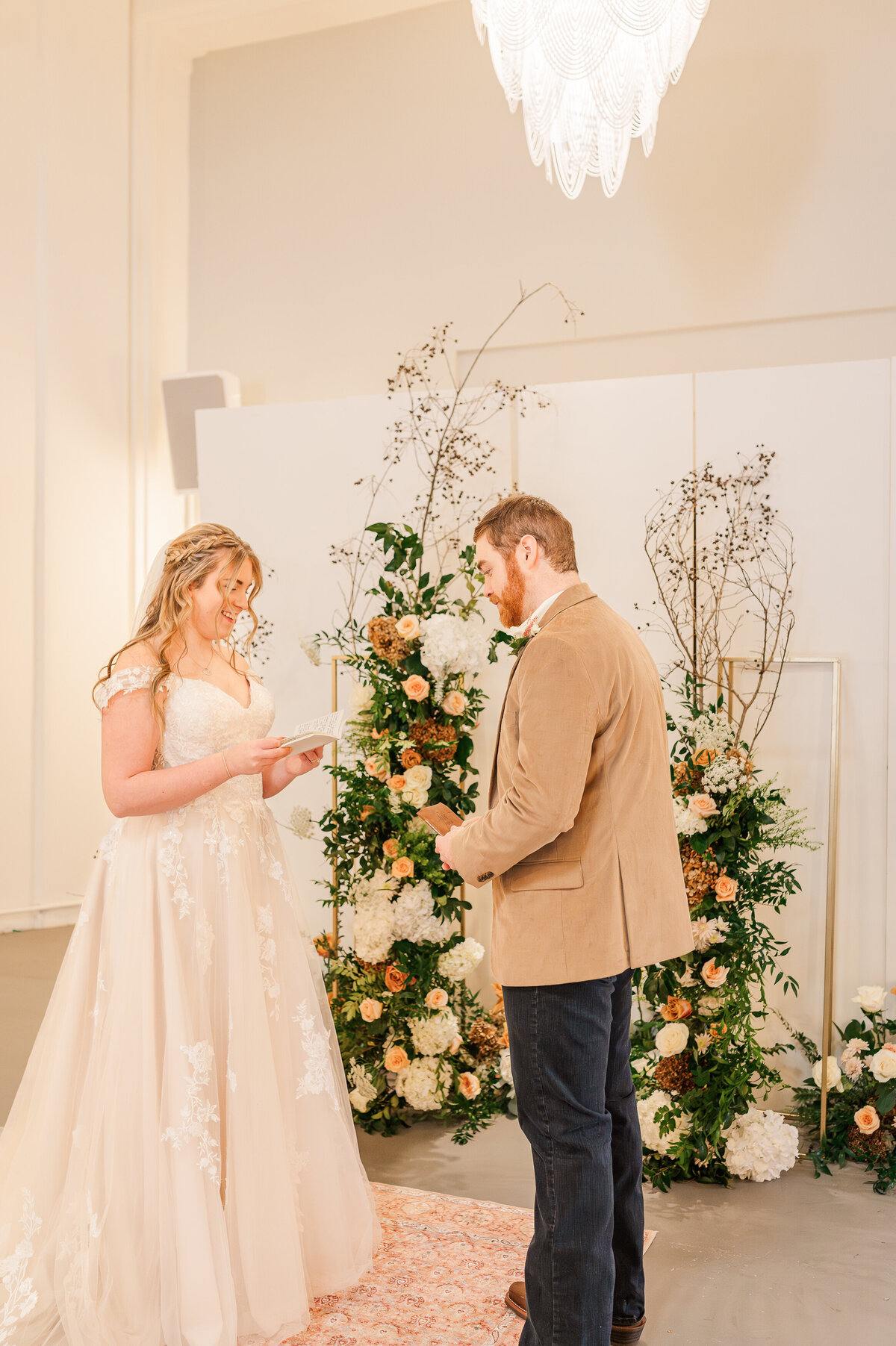 A happy couple exchanging vows at their wedding ceremony in Oxford enjoying their Raleigh wedding photography with JoLynn Photography