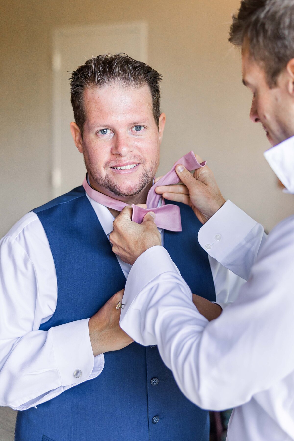 groom-and-groomsman-putting-on-tie