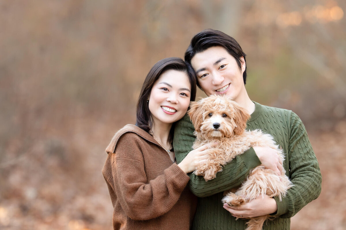 Happy Boston couple posing with their puppy for dog photos