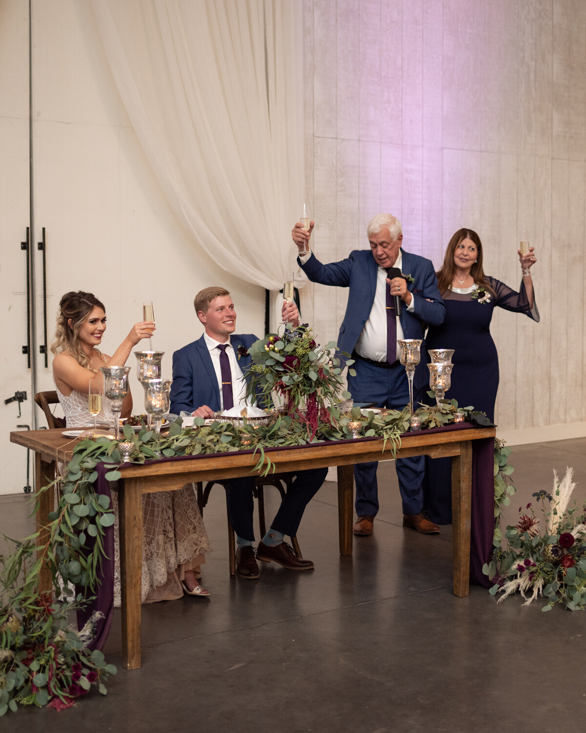 Bride's parents give a toast during wedding reception at The Woodlands