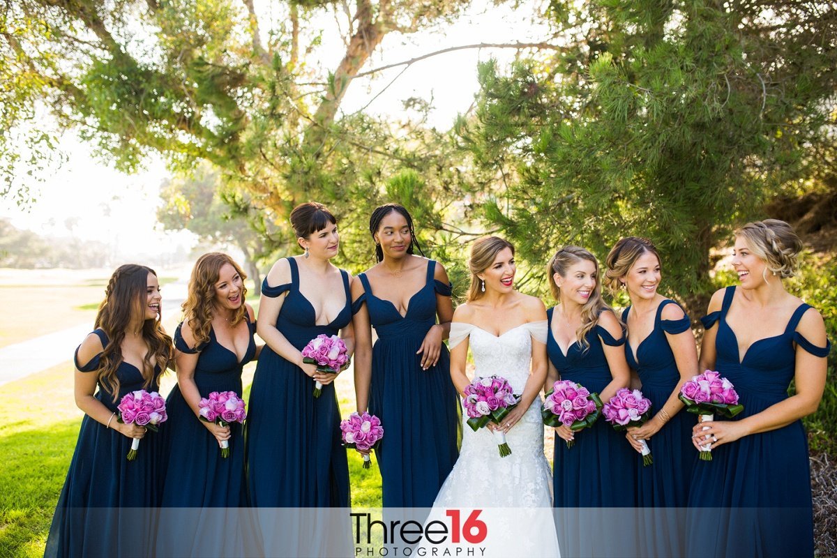 Bride and  Navy-Blue dressed Bridesmaids share a laugh together
