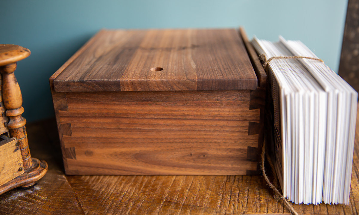 Wooden keepsake wedding box on a shelf.
