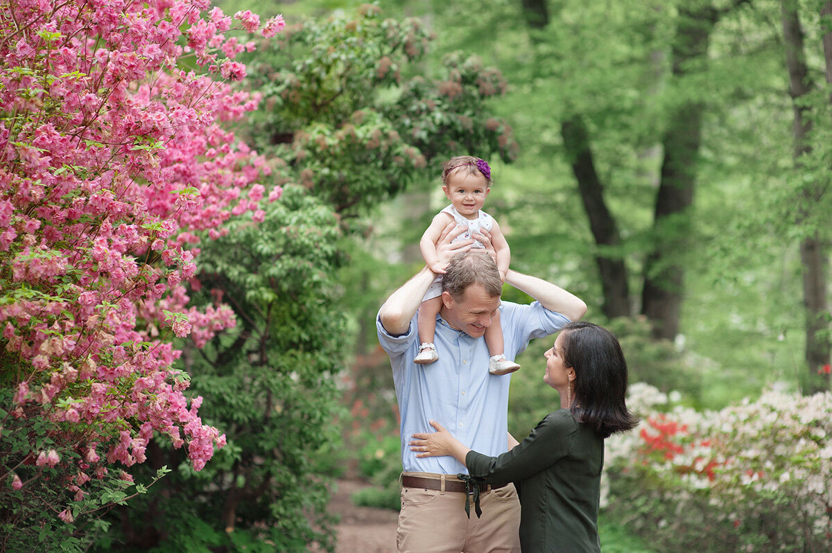 Family session located outside with pink flowers