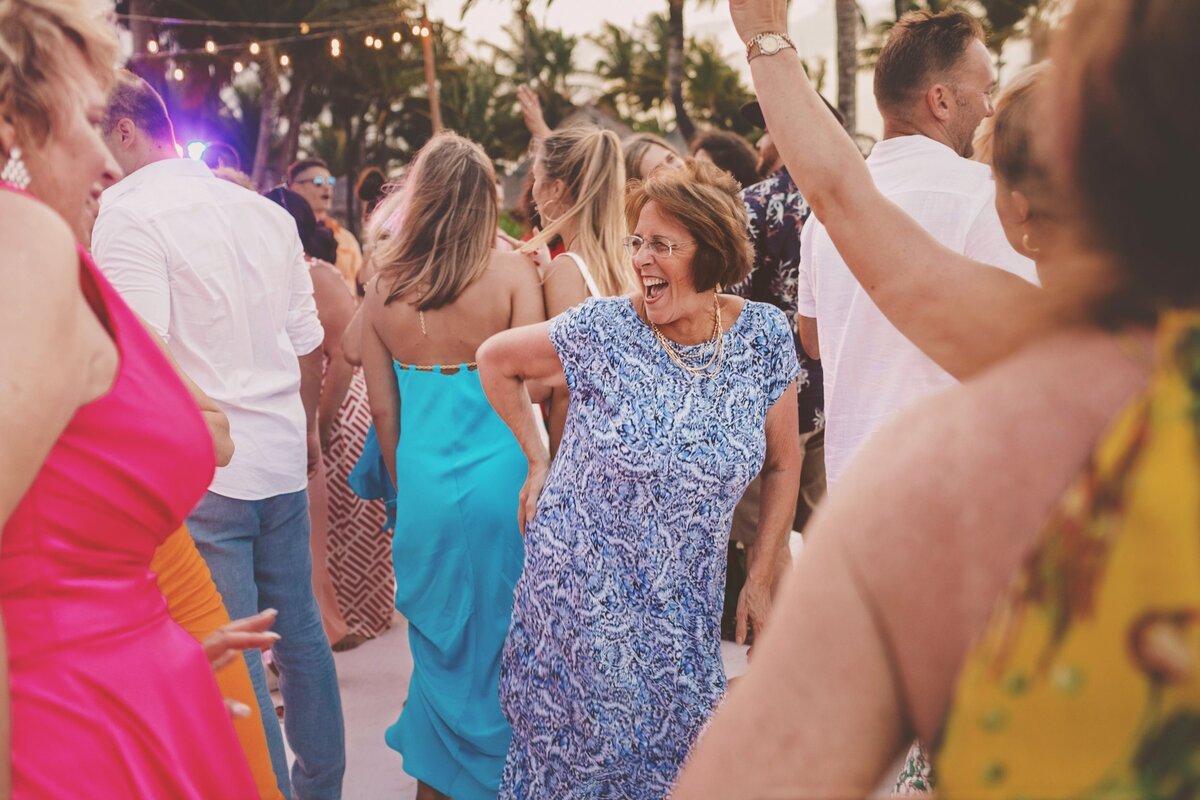 Older lady dancing at wedding reception in Cancun