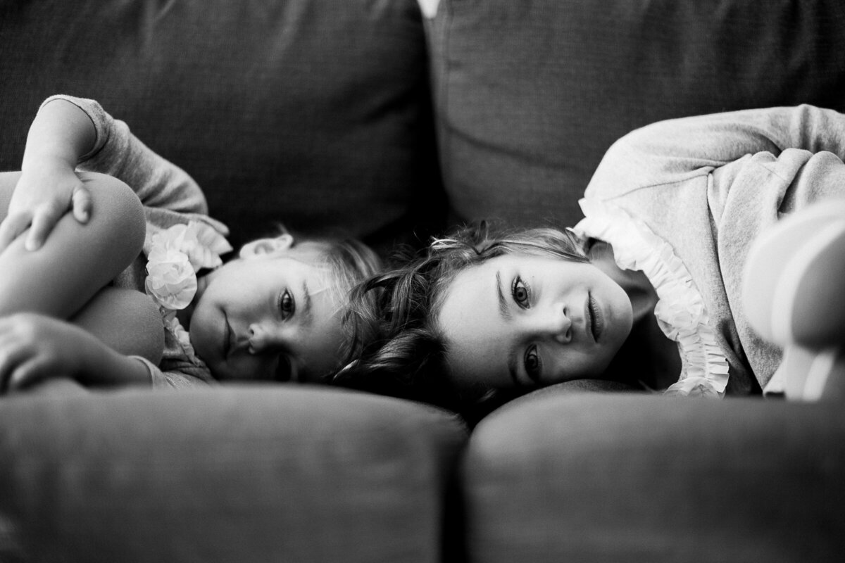 colorado sisters pose on a couch during a photo session