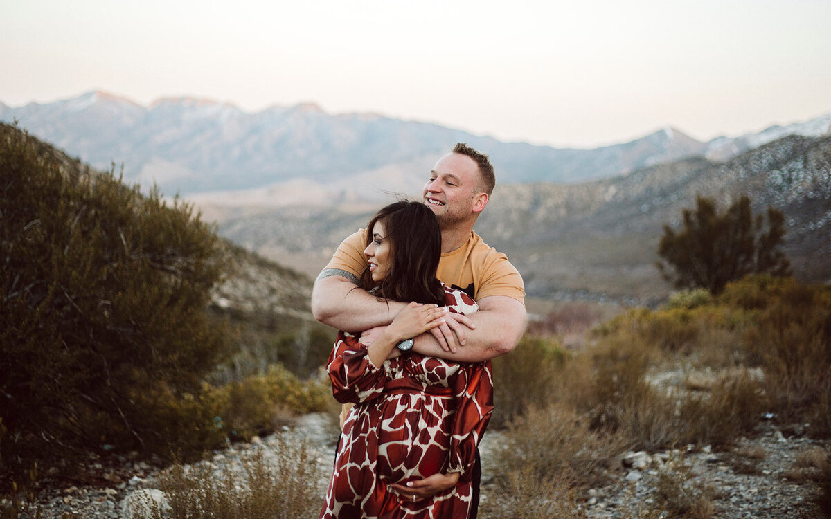 a couple hugging in the mountains