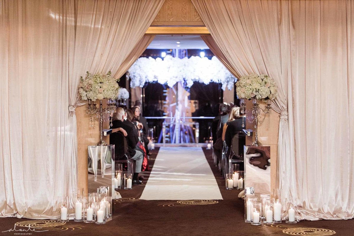 This Luxury wedding ceremony has it all, white pave flowers, mirrors, candles  and crystal everywhere.