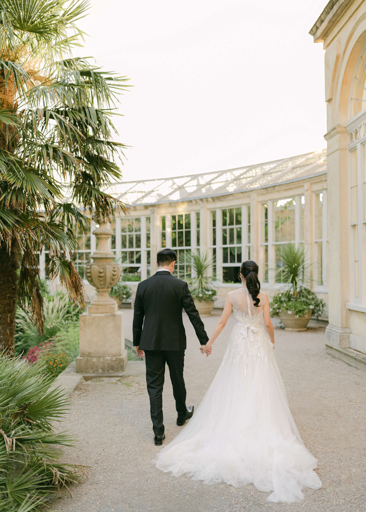 chloe-winstanley-weddings-syon-park-elie-saab-couple-conservatory-walking