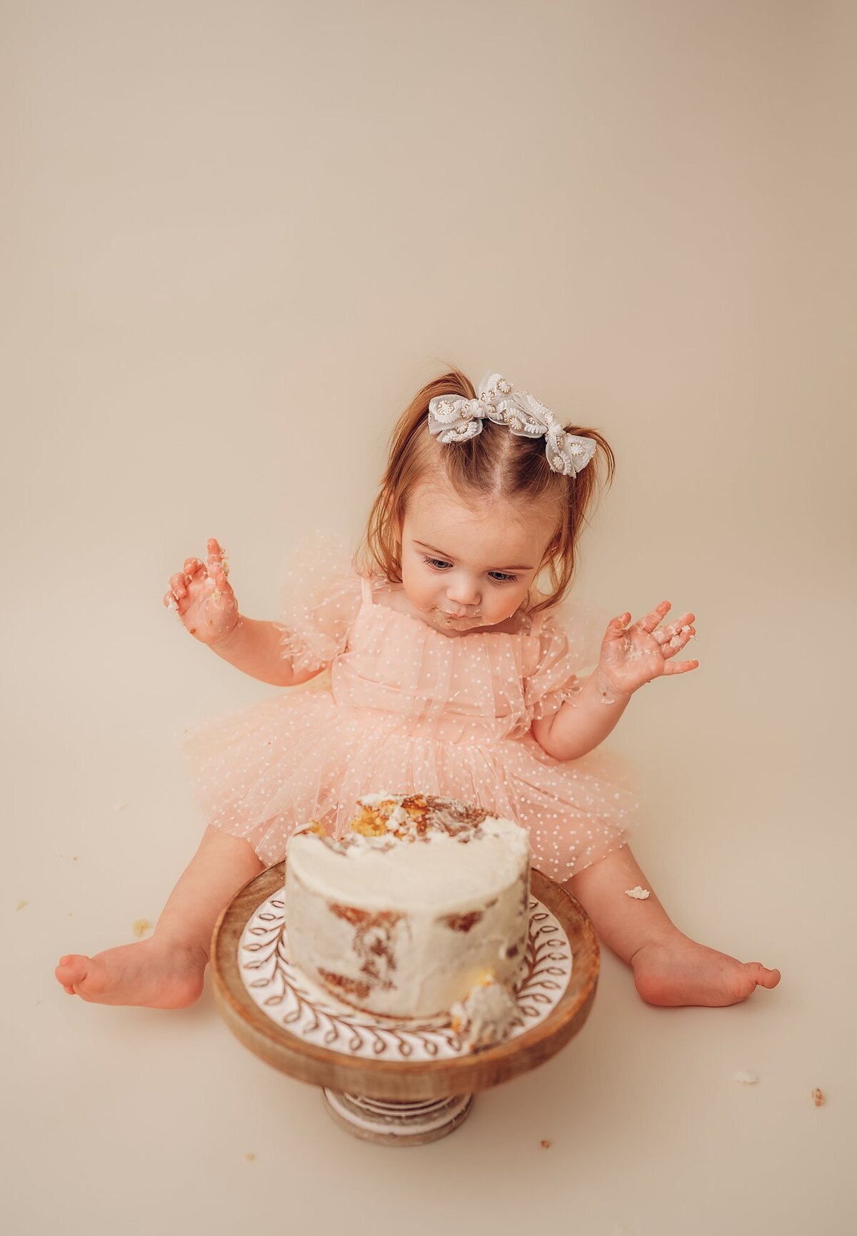 baby girl smashing cake