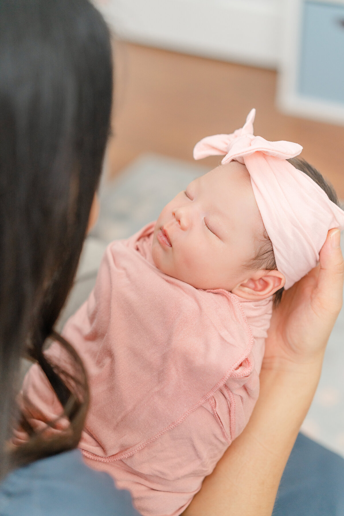 baby girl wrapped in blush pink fabric