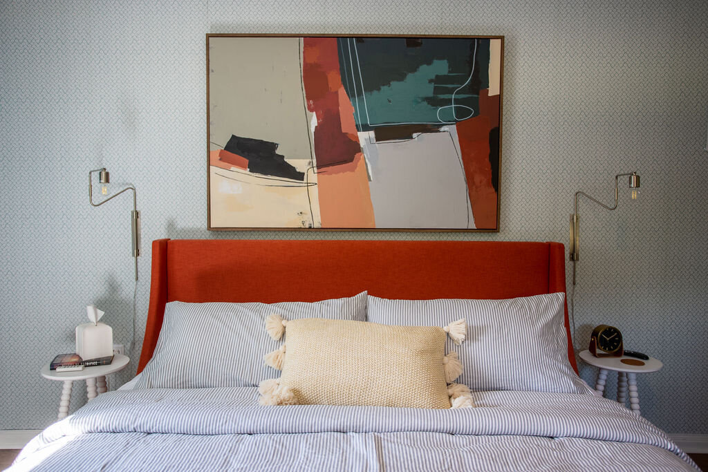 Beautiful bed with plush bedding in this three-bedroom, two-bathroom mid-century house that sleeps 8 and boasts a unique experience in color, style, and lifestyle products located in the heart of Waco, TX.