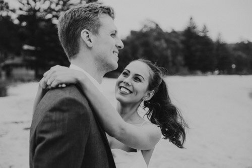 Wedding photograph from the Hunter Valley or a North Coast beach. Happy, relaxed, natural image of a couple cuddling and laughing.
