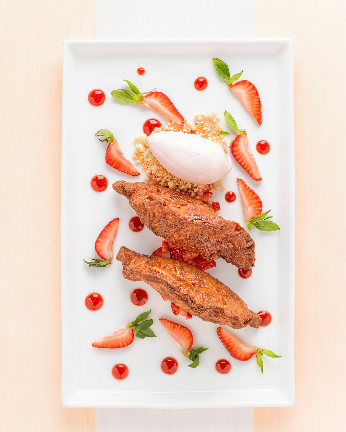 A dessert on a plate with strawberries