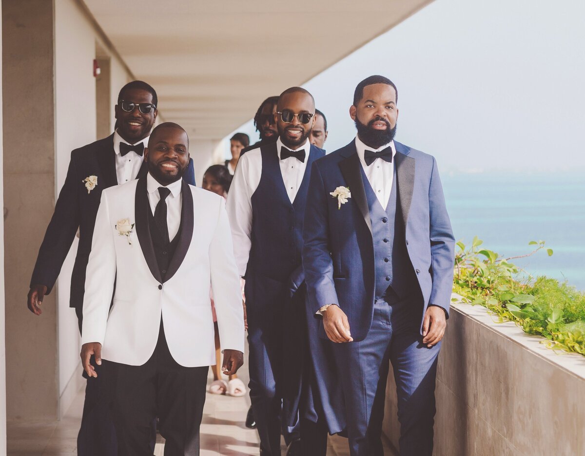 Groom and groomsmen walking to wedding in Cancun