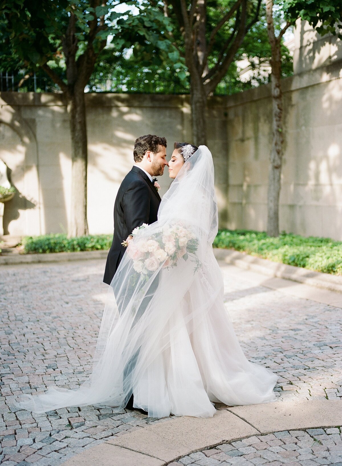Bride and groom embracing outside of wedding venue
