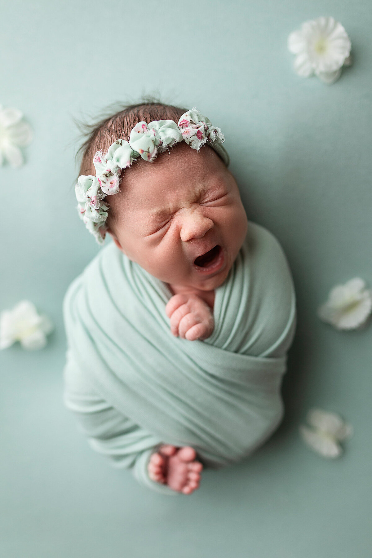 Little girl yawns during her newborn session in Southern Minneota.