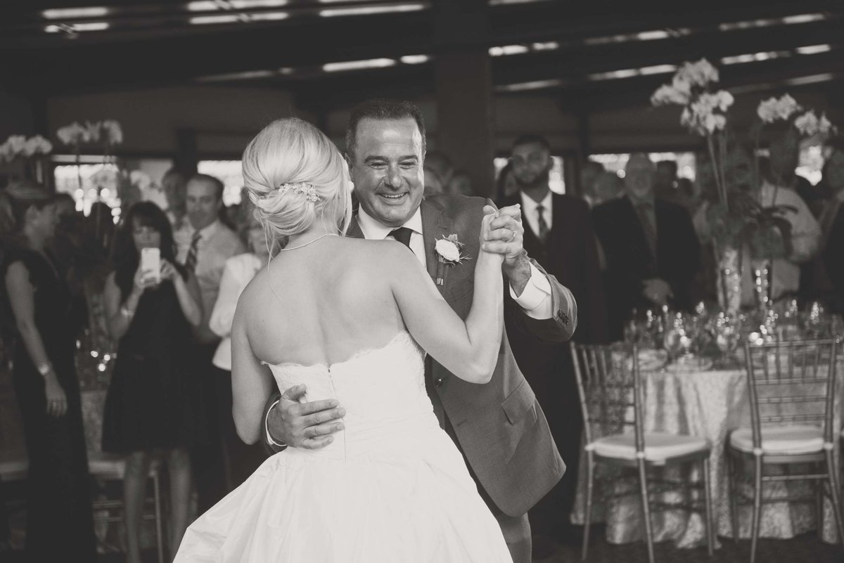 Bride and groom dancing in black and white at Huntington Crescent Club