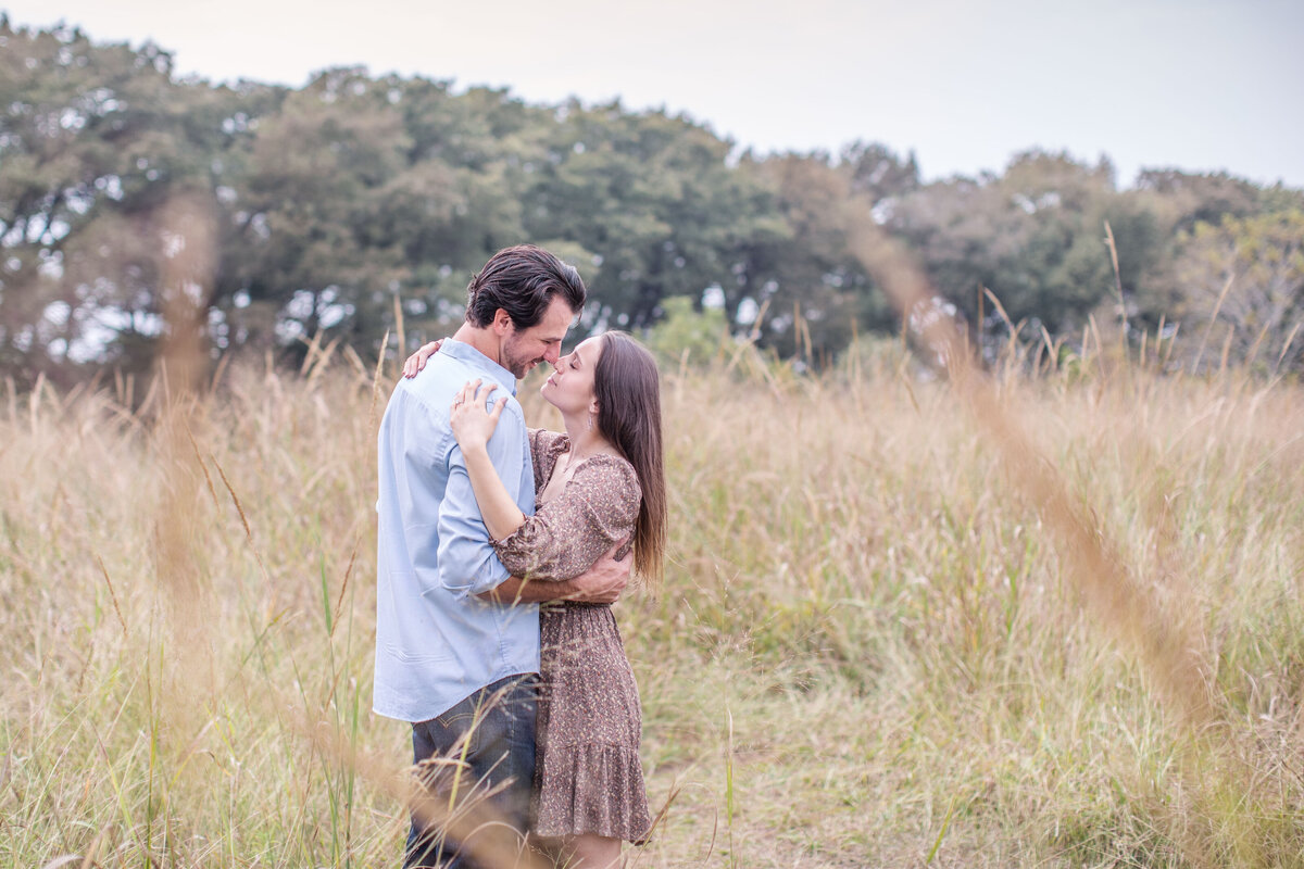 brown dress blue shirt engagement session at Cibolo Creek Nature Center in Boerne Texas by light and airy wedding photographer