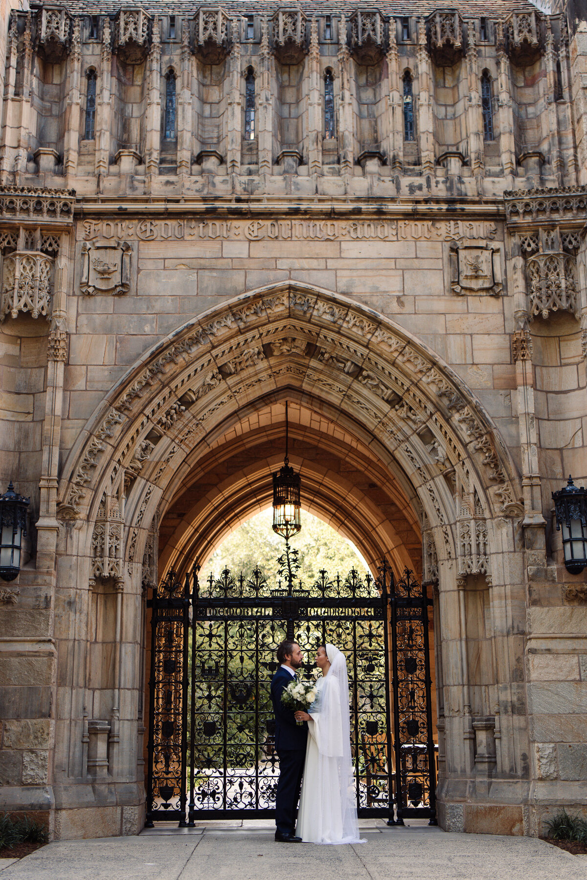 Wedding Couple standing in front of Yale Ivy League Gate in New Haven, CT