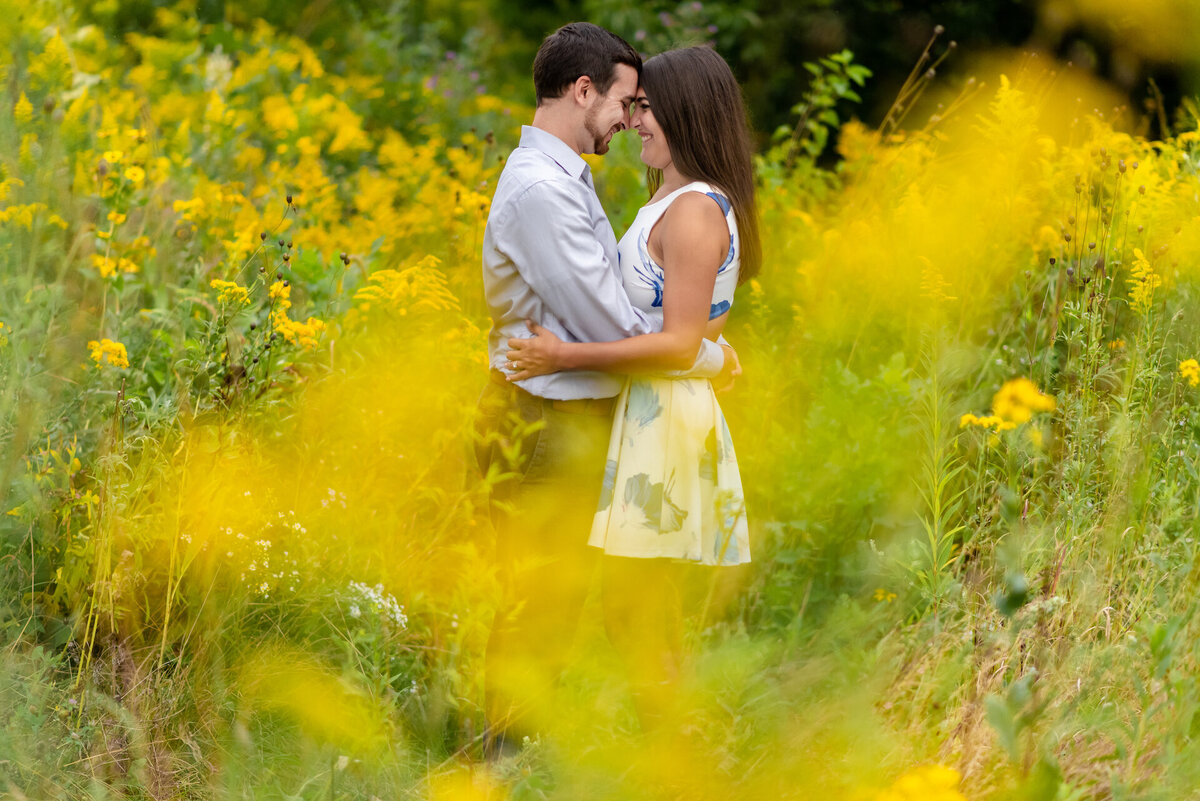 Yellow flowers surround a couple in a park