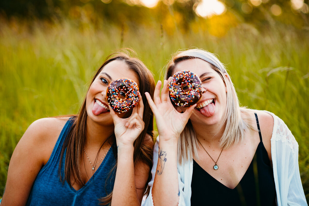 photo of girls holding donuts