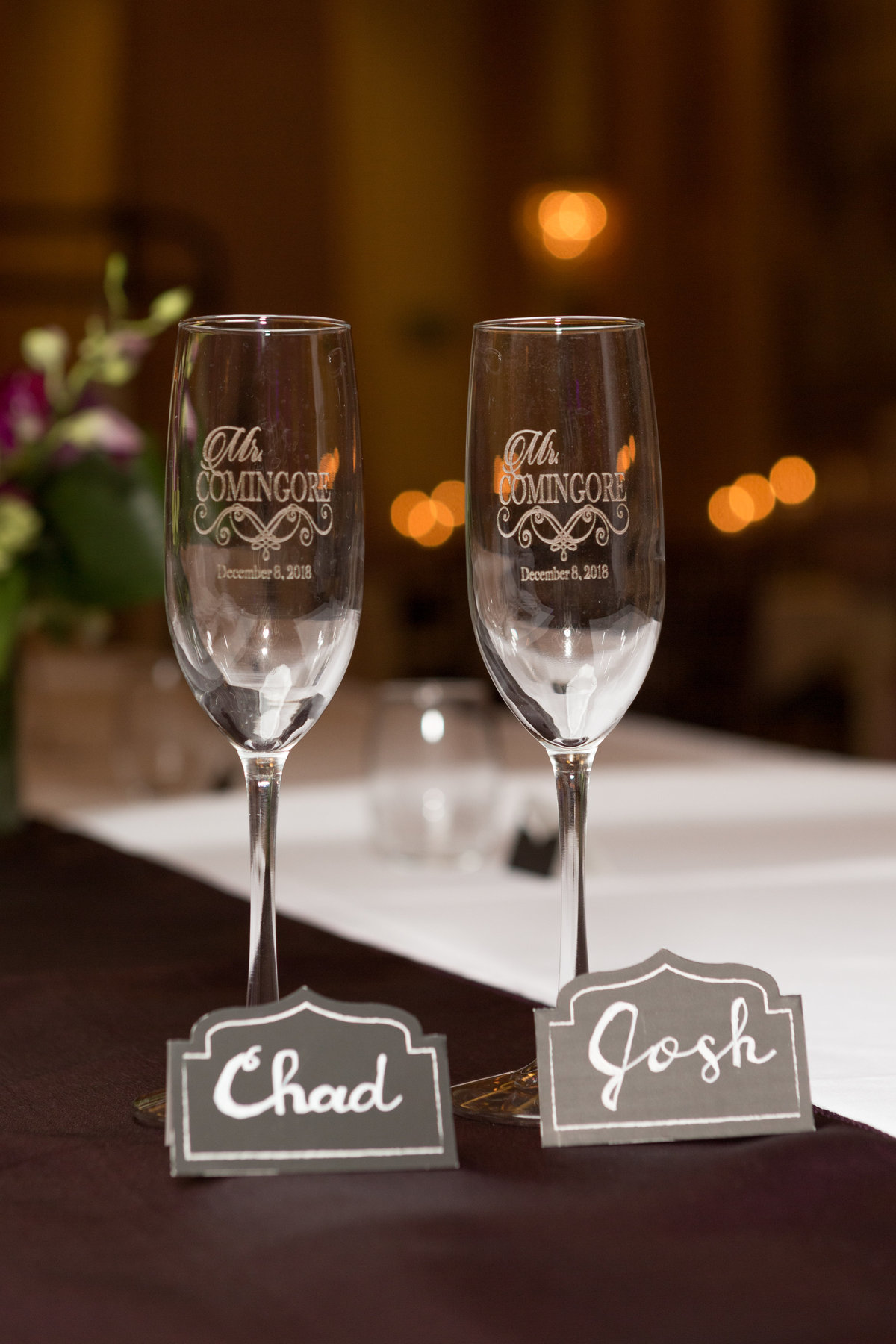 Chad & Josh's toasting glasses at their wedding reception at The Crystal Ballroom of The Battle House Hotel in Mobile, Alabama.