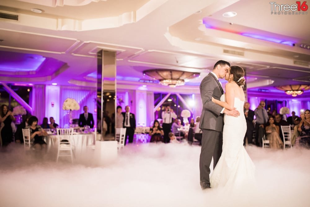 Newly married couples first dance with fog cover on the dance floor
